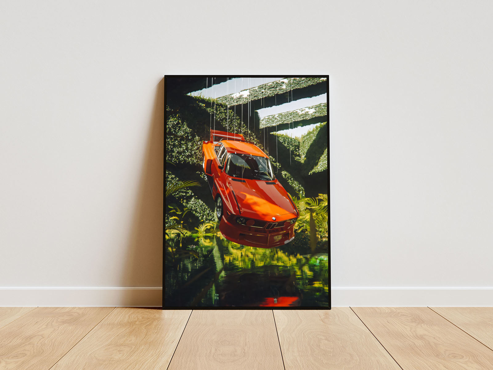 Poster mit Rahmen vom BMW Auto in verscheidenen Winkeln welches in der Luft schwebt über wasser und mit Natur grün im Hintergrund oranger BMW weiß grün orange